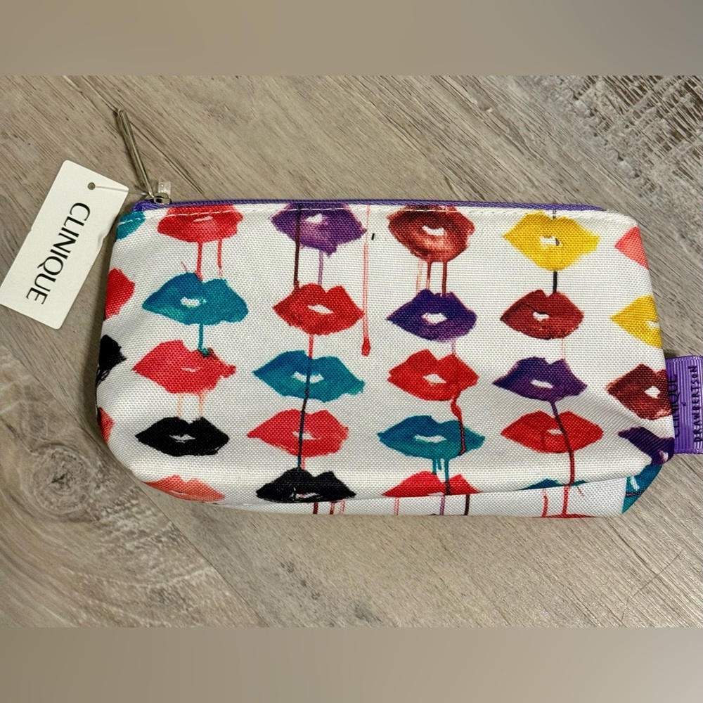 Clinique cosmetics bag is adorned with a vibrant print featuring colorful lips.